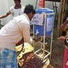 Rohingya refugees use a handwashing station, installed to help combat the spread of COVID-19 at a settlement in Cox's Bazar, Bangladesh.