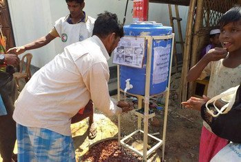 Rohingya refugees use a handwashing station, installed to help combat the spread of COVID-19 at a settlement in Cox's Bazar, Bangladesh.