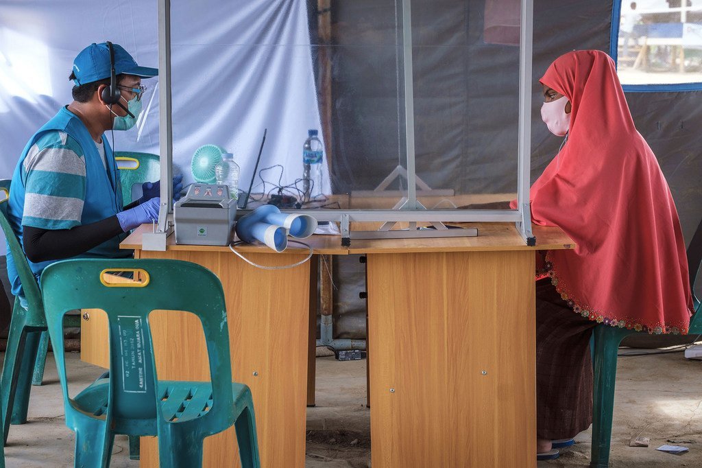 联合国难民署的工作人员正在为一名罗兴亚难民进行信息登记。