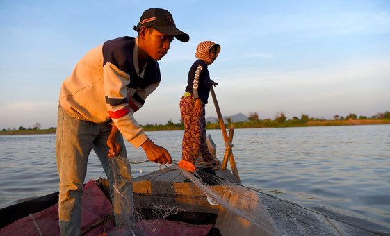 A young boy pulls a fishing net from the river at Kandal village in Kampong Chhnang, Cambodia.
