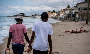 Two teenage brothers from Gambia who travelled across the Mediterranean Sea without their parents walk along a beach in Italy in 2016.