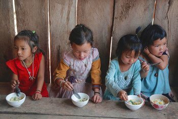 老挝丰沙里省，儿童正在由欧盟支持的健康普及中心内食用米粥。