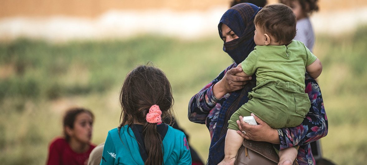 Una mujer y sus hijos llegan a Tal tamer después de ser desplazados por la guerra en el noreste de Siria.