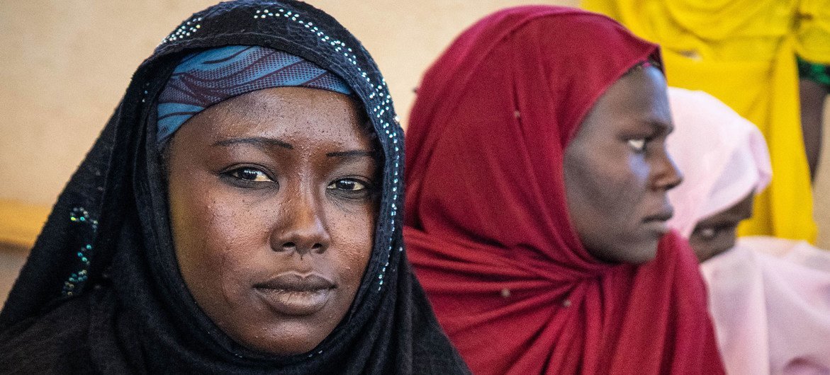 Two displaced women sit at a camp in Awaradi, Niger.