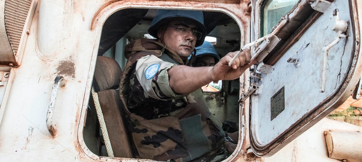 A Moroccan peacekeeper serving with MINUSCA sits in a UN armored vehicle on patrol in Bangassou, Central African Republic.