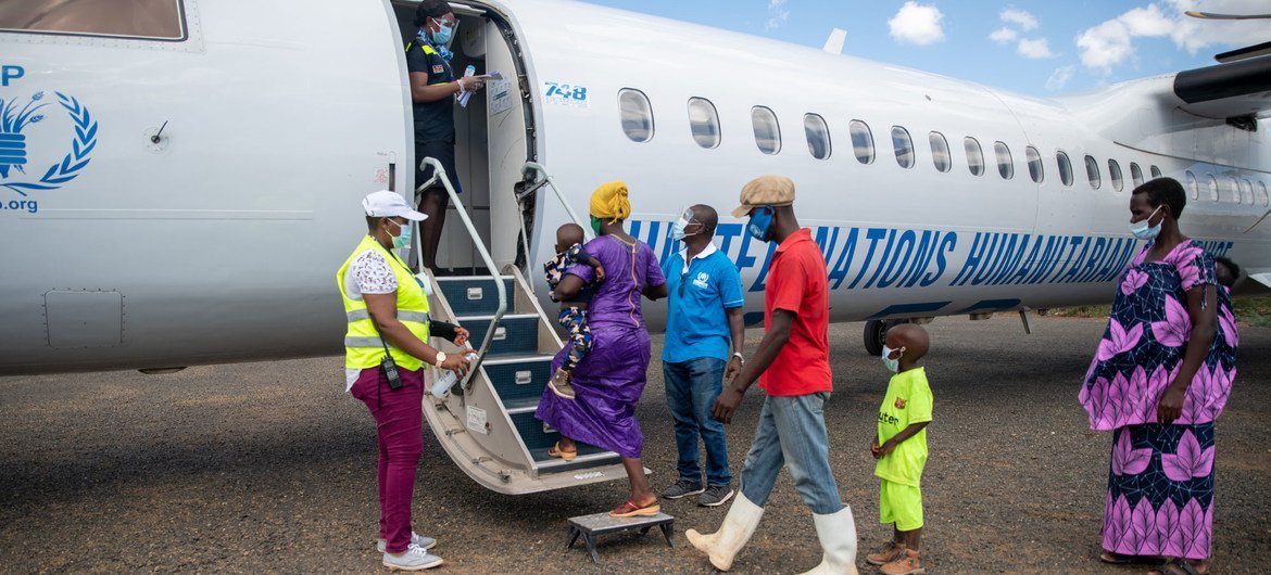 Refugees from Burundi prepare to board a flight back home in December 2020.