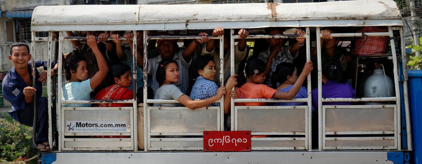 People ride a bus in Yangon, the largest city in Myanmar.