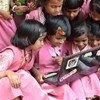 Des filles étudient grâce aux technologies.