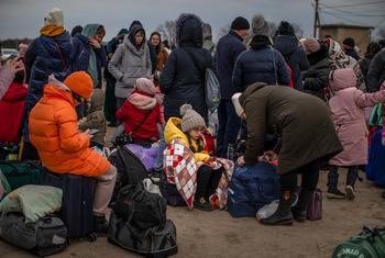 Ukrainian refugees, some with children, arrive at the Palanca border crossing in Moldova.