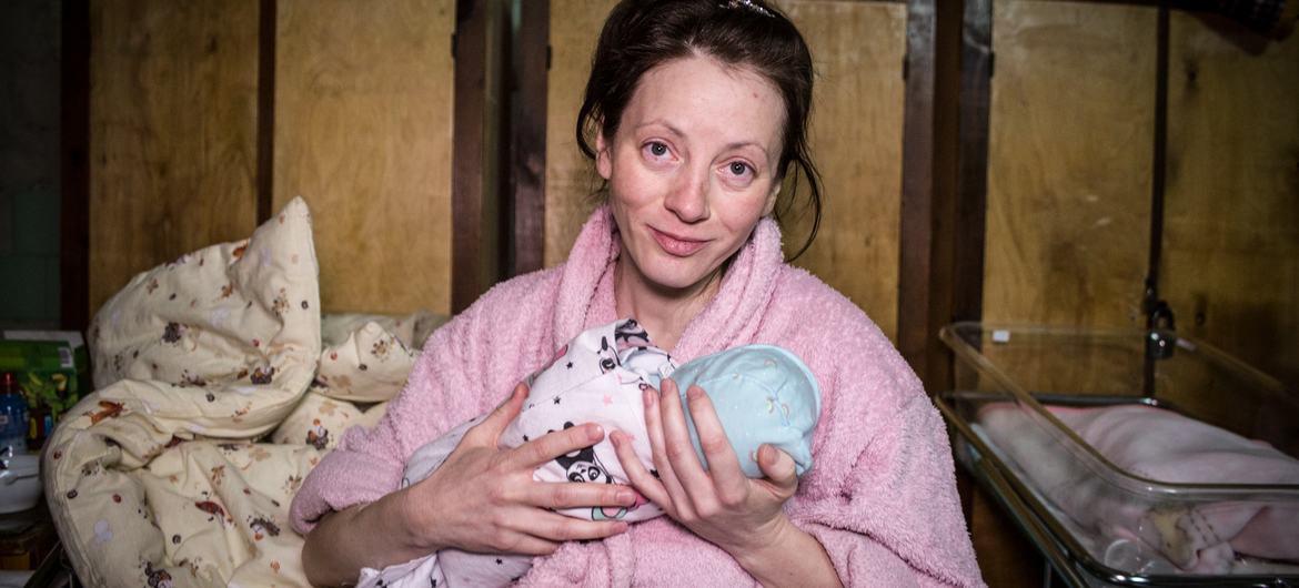 A woman holds her newborn baby in a makeshift ward at a perinatal centre in Kyiv, Ukraine.