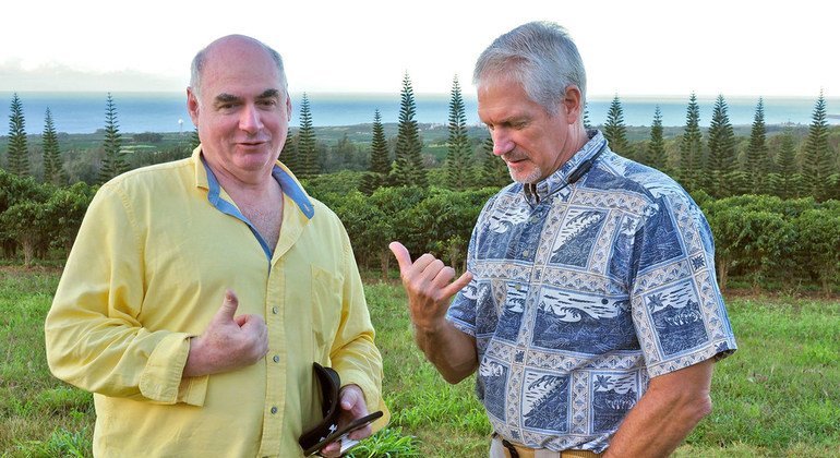 Fred Cowell (right), the General Manager of Kauai Coffee Company talks to Kevin Cassidy, the Director of the ILO Office for the United States.