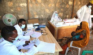 Medical workers at a UN-supported clinic near the Ceel Jaale IDP camp in Belet Weyne, Somalia, attend to a mother and her child.