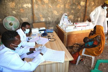 Medical workers at a UN-supported clinic near the Ceel Jaale IDP camp in Belet Weyne, Somalia, attend to a mother and her child.