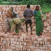 Workers stack bricks at a factory near Dhaka in Bangladesh.