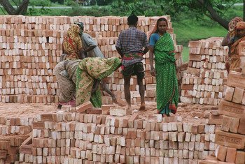 Workers stack bricks at a factory near Dhaka in Bangladesh.