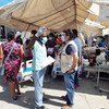 2021年8月14日，海地发生7.2级地震一天后，粮食计划署海地主任皮埃尔·霍诺特(右)在海地耶雷米的圣安托万医院与一名工作人员交谈。