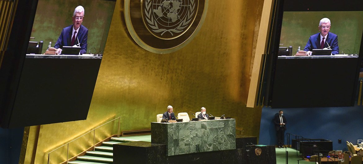 Volkan Bozkir (left at dais and on screens), President of the 75th session of the United Nations General Assembly, chairs the first plenary meeting of the 75th session of the General Assembly.