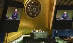 Volkan Bozkir (left at dais and on screens), President of the 75th session of the United Nations General Assembly, chairs the first plenary meeting of the 75th session of the General Assembly.