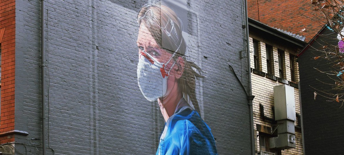 A mural on a wall in Manchester, England, depicts a NHS nurse.