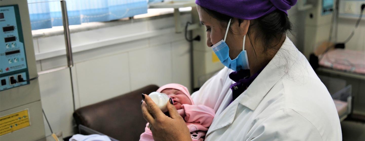 The head midwife at Kabul's Malalai Maternity Hospital attends to a newborn.