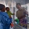 A five-month-old baby smiles when he sees his mother through the plastic that separates them at an Ebola Treatment Centre (ETC) in Beni, North Kivu province, Democratic Republic of the Congo.
