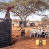 A man collects water from a water tank in Kenya.