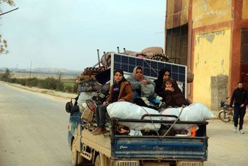 Women and children ride in the back of a truck as families flee from Saraqeb and Ariha in Syria's south rural Idlib Governate to escape escalated conflict.