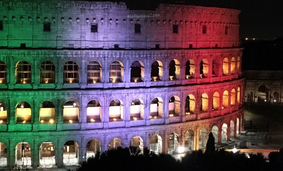 The Colosseum in Rome, Italy, illuminated with the message I stay at home.