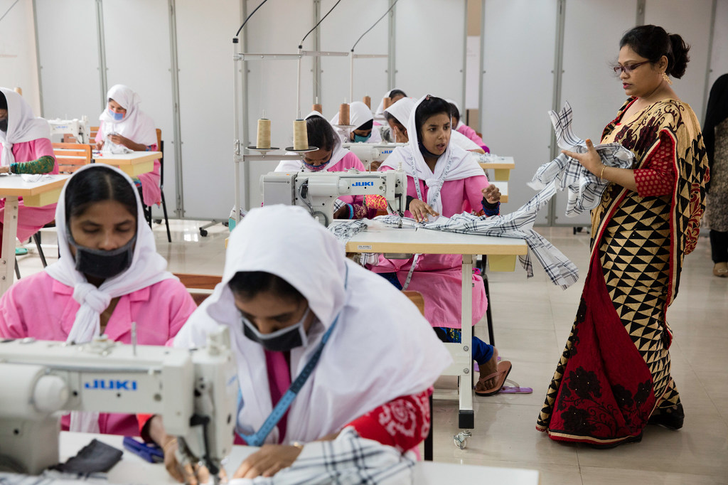 Young women being trained to make shirts in Dhaka, Bangladesh.