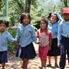 A group of school children walk hand in hand after school in rural Nepal.