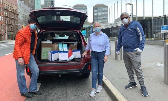 Robert Macpherson, Patricia Nemeth  and Yogesh Sakharande of the UN Staff Union load items to be taken to local hospitals in New York City.