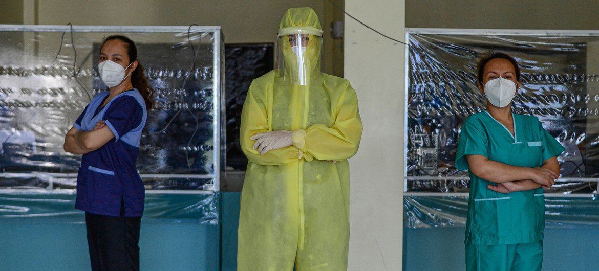 Wearing a full protective suit, a woman doctor who leads a group of volunteer medical professionals attending to COVID-19 patients and persons under investigation at a community hospital in the Philippines.