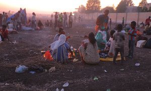 Ethiopian refugees fleeing clashes in the country's northern Tigray region, rest and cook meals near UNHCR's Hamdayet reception centre after crossing into Sudan.
