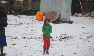 A child walks in the falling snow at a recently established informal settlement which continues to receive newly displaced families from southern Idlib and rural Aleppo governorates in northwest Syria.