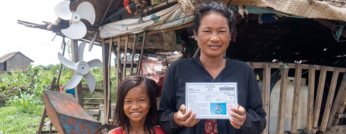 A Cambodian woman shows her government-issued IDPoor card.  