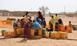 A group of displaced women collect water in the town of Djibo in Burkina Faso.