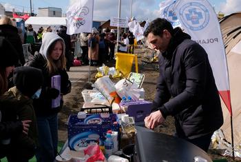 متطوعون يقدمون الإمدادات للأطفال والعائلات الذين يصلون إلى بولندا بعد فرارهم من أوكرانيا.