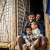 A Rohingya refugee family sit in the doorway of their new monsoon-ready shelter in Cox’s Bazar, Bangladesh.