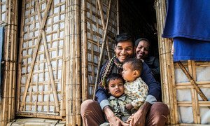A Rohingya refugee family sit in the doorway of their new monsoon-ready shelter in Cox’s Bazar, Bangladesh.