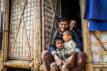 A Rohingya refugee family sit in the doorway of their new monsoon-ready shelter in Cox’s Bazar, Bangladesh.