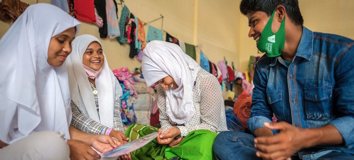 After a seven-month ordeal at sea, a Rohingya refugee from Myanmar reunites with his sister (centre) in Aceh province, Indonesia.