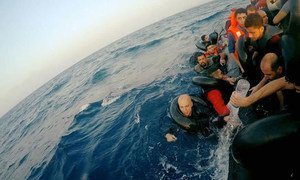 Syrian filmmaker, Hassan Akad (pictured here on the left, in the water) crossed the Mediterranean sea to seek refuge in Europe.