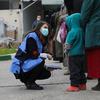 An OCHA protection officer speaks to vulneratble people in Damascus, Syria.