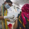 COVID-19 vaccinations are administered at a hospital in Odisha, India.