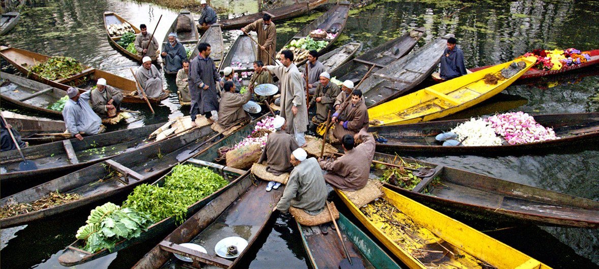 As countries face more political, technical, socioeconomic and other barriers, increased climate ambition is central  to mitigate and adapt to climate change. Vendors are photographed in Kashmir before going to a floating market.