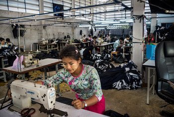 A migrant worker sews clothes in a factory in western Thailand. 