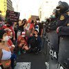 A group of protesters kneeling in front of police officers during demonstrations in Lima, Peru, in November 2020.