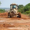 A UNMISS grader constructs a road in a rural area of South Sudan.