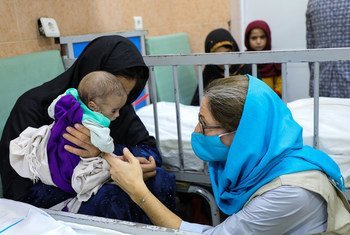 UNICEF Afghanistan's chief of communication, Sam Mort, interacts with a child at a malnutrition treatment ward at the Indira Gandhi Children's Hospital in Kabul..