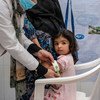 Two-year-old Fatima has her nutritional status screened at Bab-e-Bargh health centre which is supported by UNICEF in Herat city's largest health clinic.